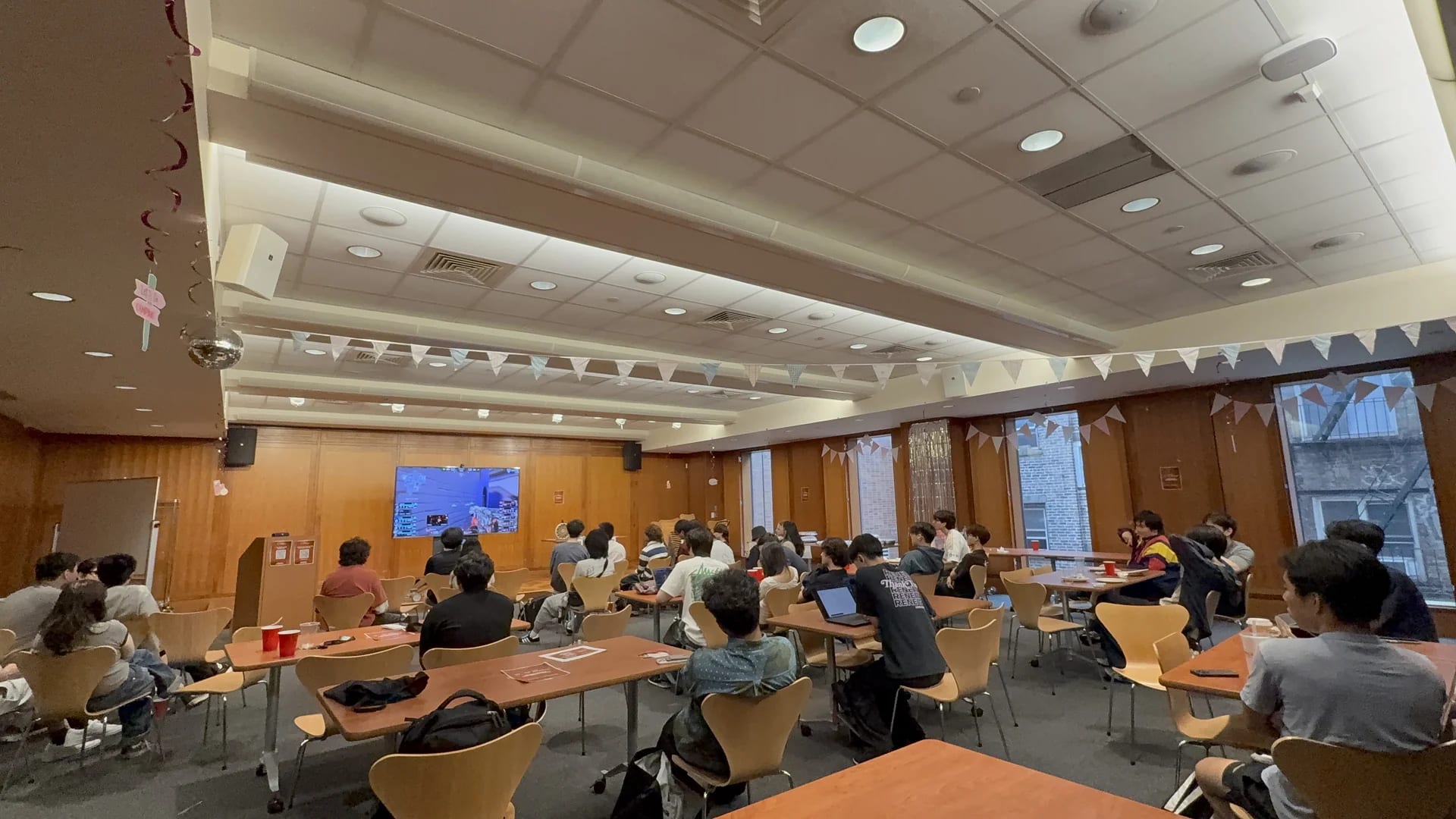 The VOP community watching VALORANT on a projected screen